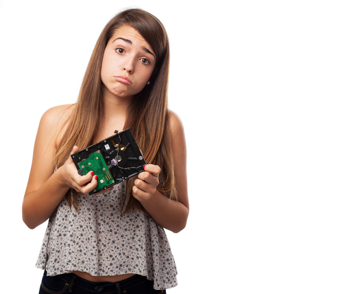 Girl holding broken hard drive