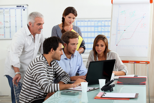 Employees around a computer