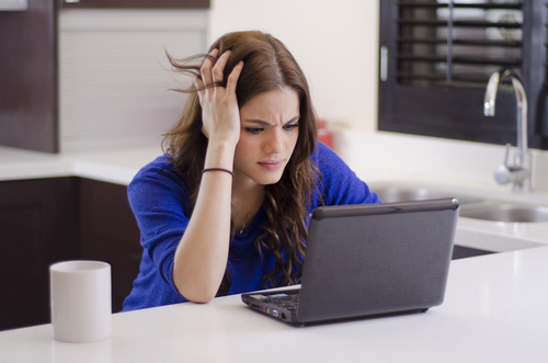 Frustrated woman at laptop