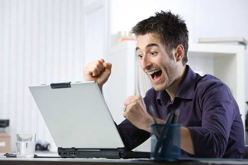 Excited man at computer