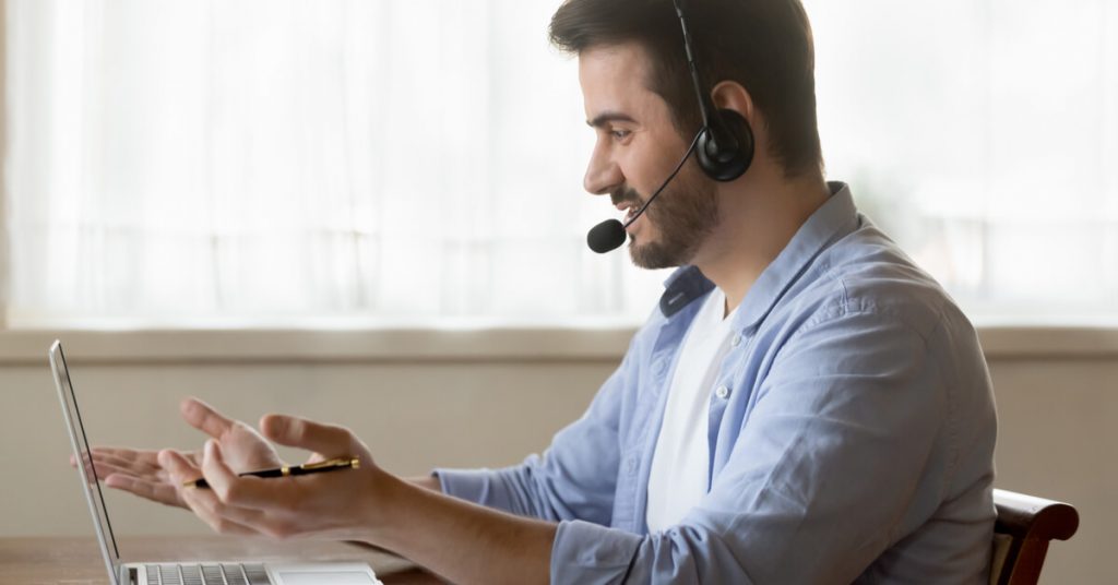 man working from home wearing headset